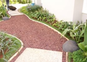 Batu alam berwarna merah untuk melapisi tanah (ground cover), pada jalan setapak.